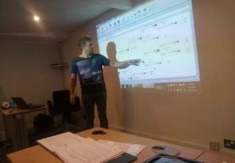 Instructor presenting a model on screen