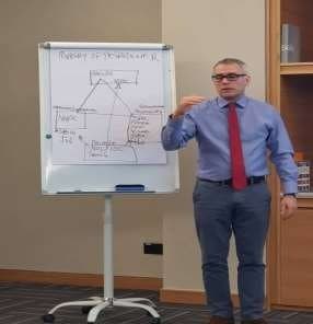 Instructor explaining a diagram on a flip chart