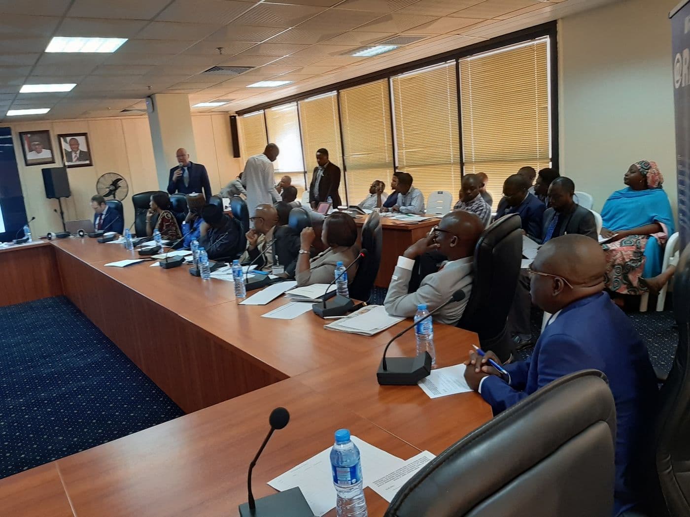 Delegates seated around the conference table