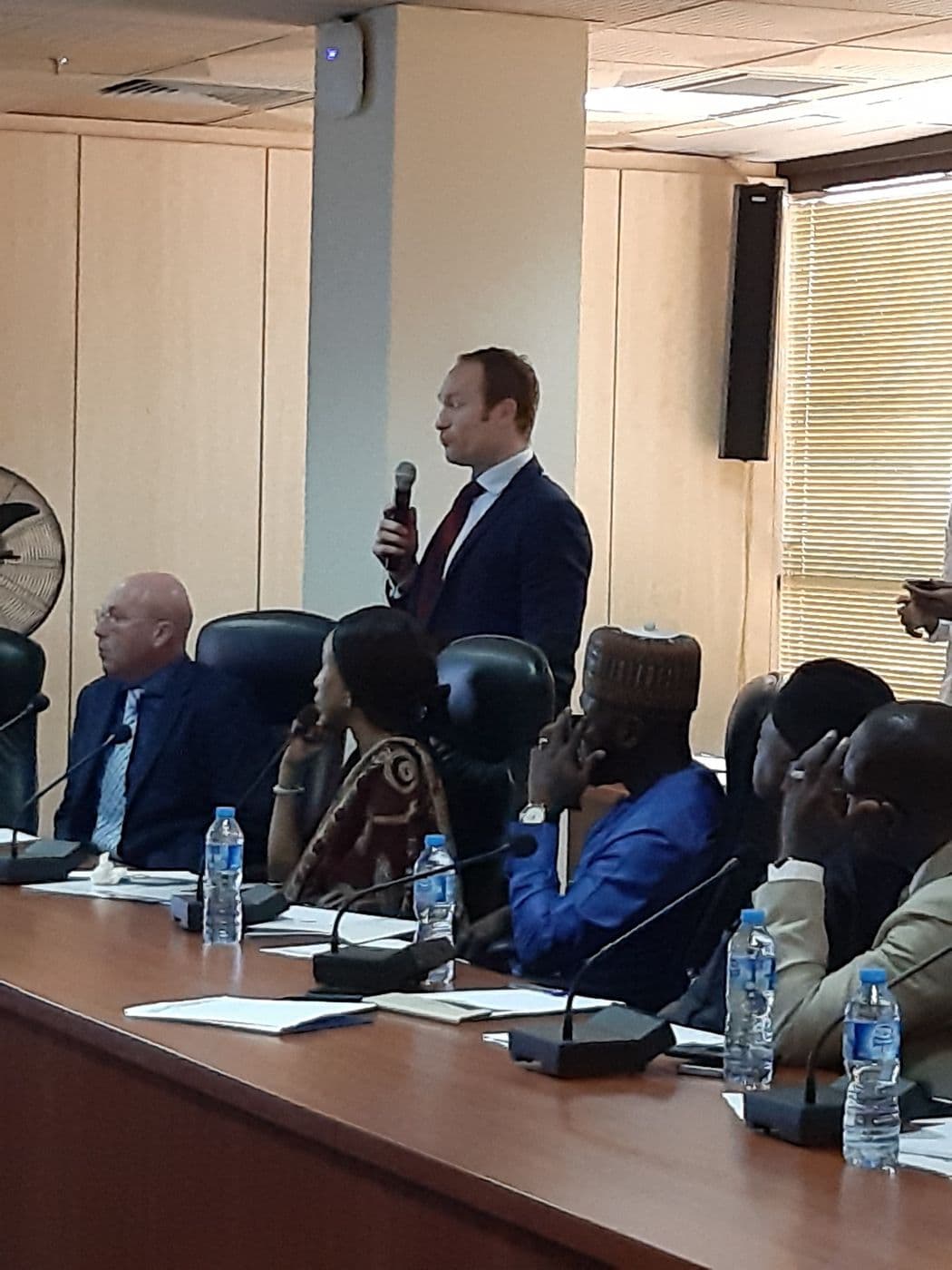 Presenter speaking to delegates at the table