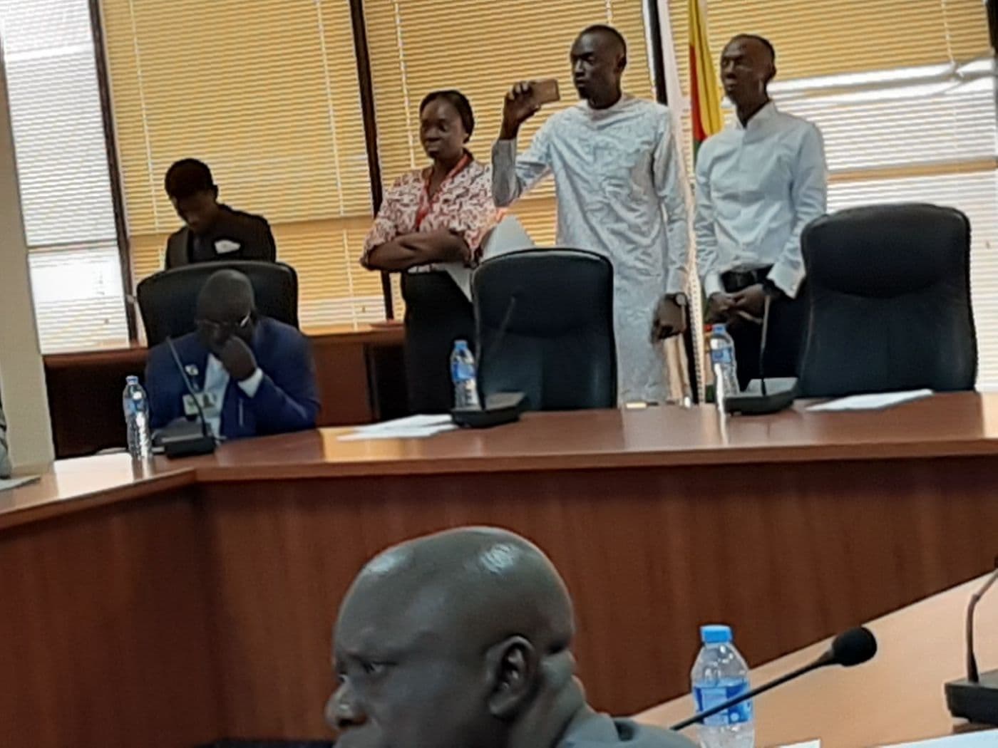Delegates standing during a discussion