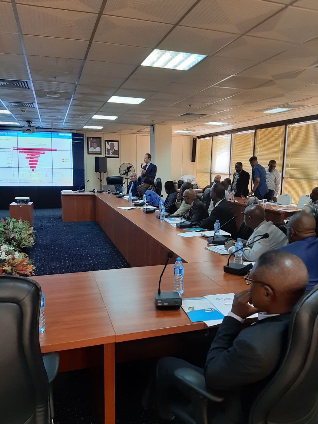 Delegates following a chart on the screen